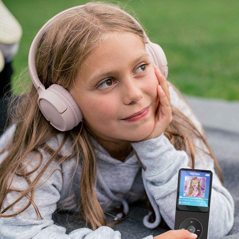 Child using MP3 player with headset outdoors, enjoying music with high-quality sound and no internet connection