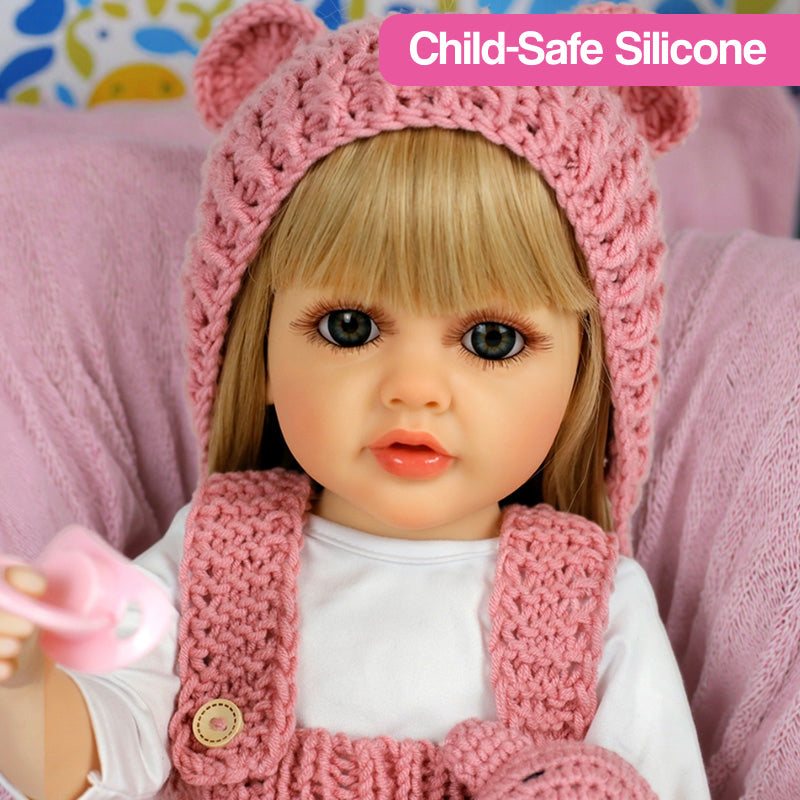 Lifelike real-feel baby doll with blonde hair, child-safe silicone, and pink knitted outfit holding pacifier