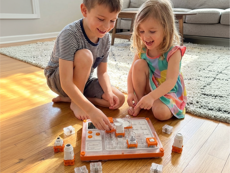 Two kids playing with the STEM Circuit Puzzle Board